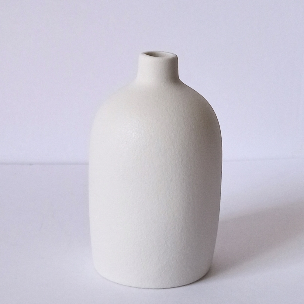 Small ceramic like white round vase